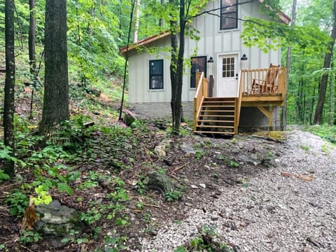 Front entryway to the cabin with the gravel trail leading down toward the firepi