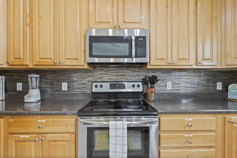 Kitchen with microwave, stovetop and oven