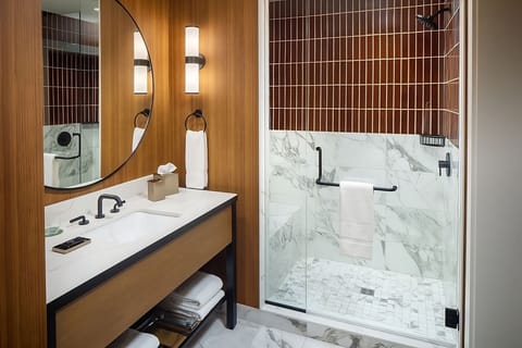 Rinse off in a bright walk-in shower with luxe finishes.