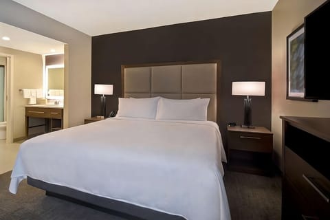 Unwind into crisp linens and a serene, modern king bed.