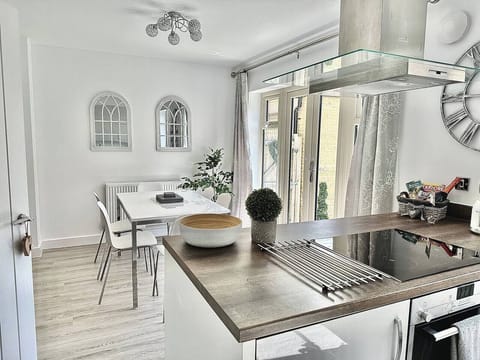 Modern sunny kitchen diner with French doors leading onto the enclosed garden. High chair available on request.