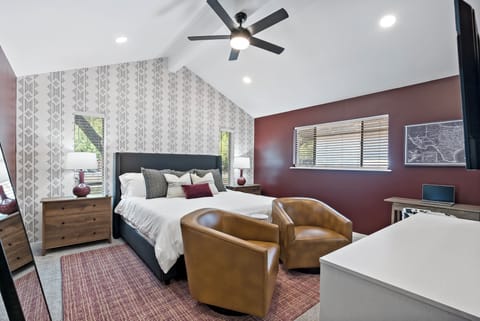 Main Bedroom: Elegant decor meets comfort with plush king bed and sitting area!