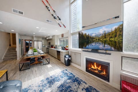 Your open-concept retreat blends mountain living with modern comfort, featuring a crackling fireplace and fully equipped kitchen for memorable evenings.