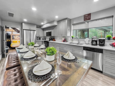 This bright, open-concept kitchen and dining area offers premium appliances and ample seating. A stylish and functional space designed for gathering, cooking, and making memories together.