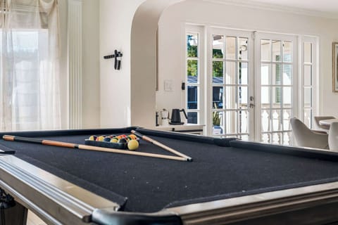 The pool table complements the room's spacious layout, providing an ideal spot for socializing and entertainment.