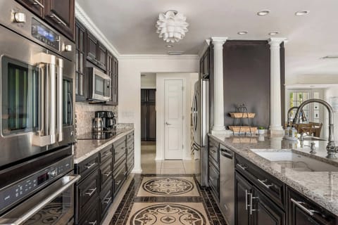 Built for efficiency and luxury, the kitchen features double microwaves, dual sinks, and both mini and full-sized fridges to cater to any culinary requirement.