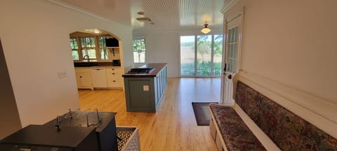 walking into kitchen/ dinning from living room. kitchen island