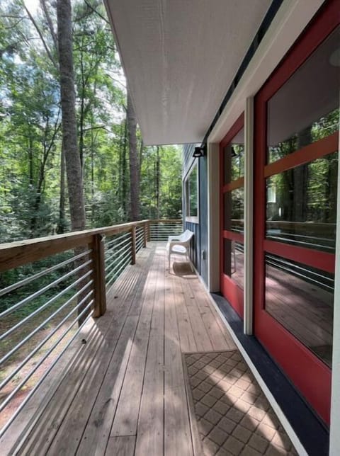 The front entrance of the modern cabin, surrounded by trees
