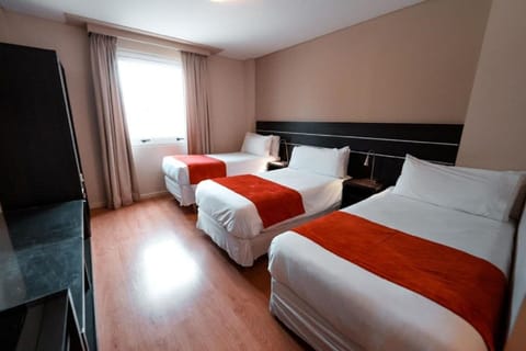 Relax in a bright, spacious room with three cozy beds.