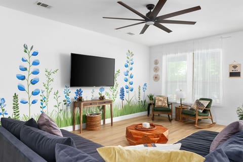 Living Room Oasis: Bright murals and comfy seating invite fun moments and lively conversations!