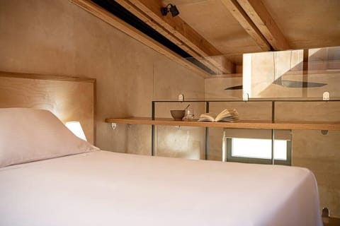 Cozy Double Bed With Rustic Wood Aesthetics And Soft, Ambient Lighting