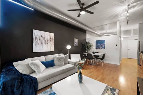 Cozy living area w/ comfy seating, wall-mounted TV, & warm lighting for easy evenings in.