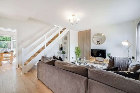 Your go-to relaxation spot! A spacious room with a large sofa and TV, ideal for lounging and unwinding in comfort