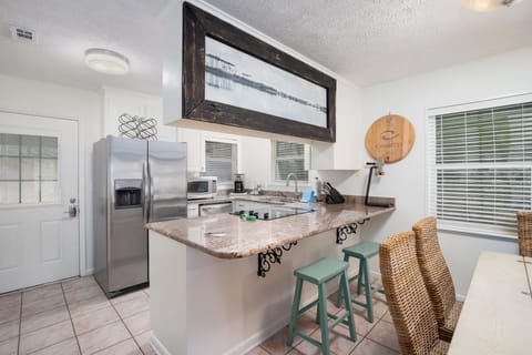 Your fully equipped kitchen invites you to create delicious meals with granite countertops, stainless steel appliances, and coastal-inspired decor.