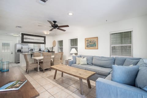 Relax in your spacious open-plan living area with comfortable blue sectional seating, perfect for unwinding after exploring.