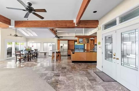 Frontdoor foyer area looking into open first floor plan kitchen and dining areas