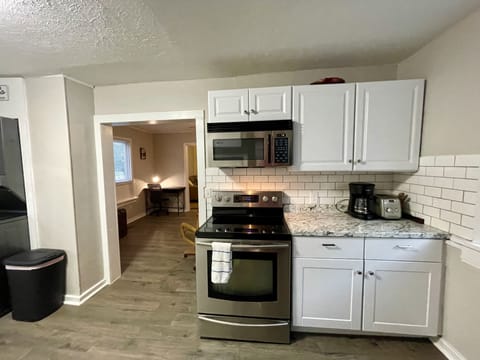 Kitchen stove; microwave; various other kitchen dishes and necessities