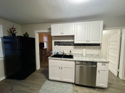 Full kitchen with large refrigerator and ice maker