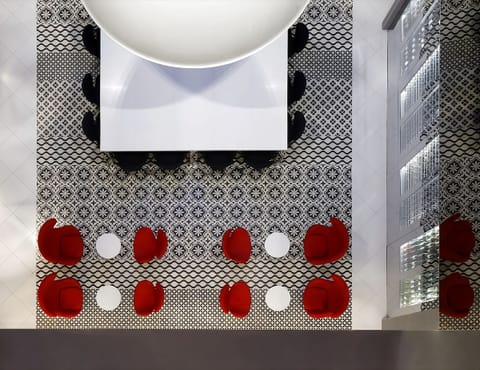 Admire bold patterned floors from a chic lounge perch.