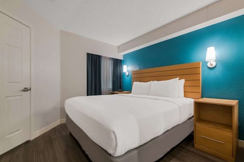 Relax in a quiet corner room with soft bedside lighting.