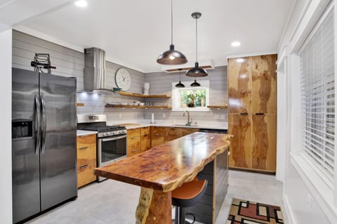 Gourmet kitchen w/site-built cedar cabinets, live edge cedar island, gas oven.