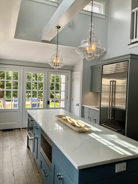 A large island with seating, refrigerator drawers, microwave drawer