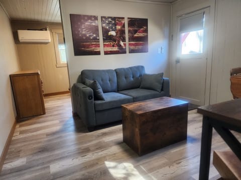 living area with  full size hide a bed love seat