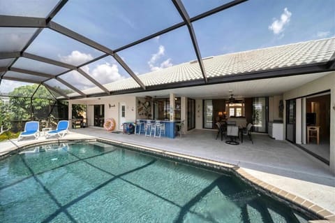 Pool, bar, and outdoor dining
