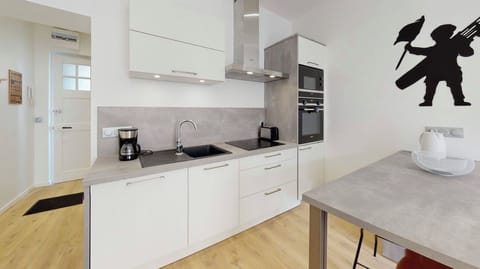 Kitchen including dishwasher, oven, fridge, microwave, induction, coffee maker.