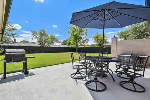 Large fenced in yard, charcoal grill and patio.