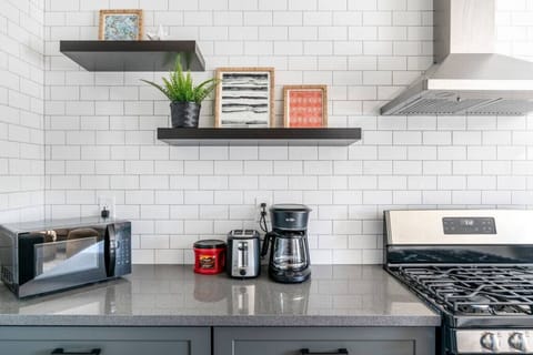 Whip up delicious meals in our kitchen, featuring a fridge, coffee maker, pots, pans, and knives for the ultimate cooking experience.