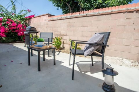 Enjoy the sunshine and fresh air in our beautiful backyard, complete with a barbecue grill for outdoor dining.