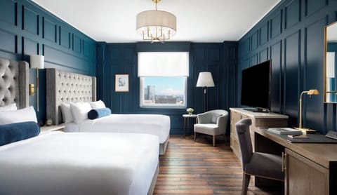 Unwind in a serene, sunlit room with plush double queens.