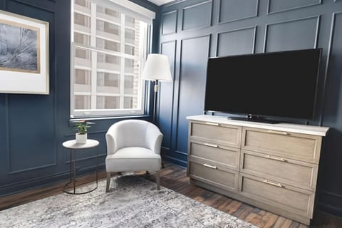 Unwind by the window with lounge chair and in-room TV.