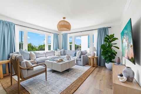 Welcome to your bright and spacious living room at our Beachside Home! Relax on comfortable seating, soak in the natural light, and enjoy your coastal getaway, just steps to the ocean.