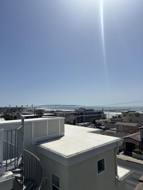 Sun-drenched rooftop patio with panoramic sky views