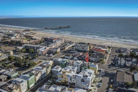 Aerial view of Pismo Beach Pier, sandy coastline & ocean – 1 block from our roof