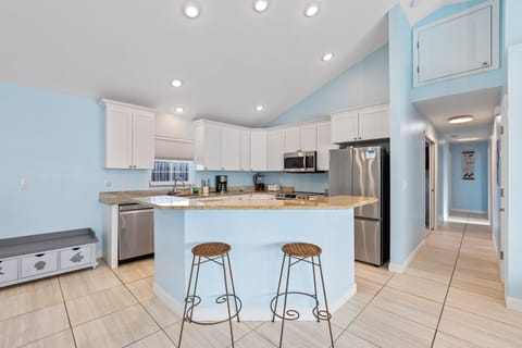 Gather around the kitchen island with stylish barstools, perfect for casual meals and conversation.