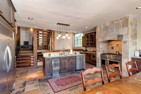 - Cook up memories in a spacious kitchen with granite counters and double ovens
- Enjoy meals in a warm, wood accented dining area with a cozy lodge feel
- Stylish lighting and stone finishes blend rustic charm with modern function