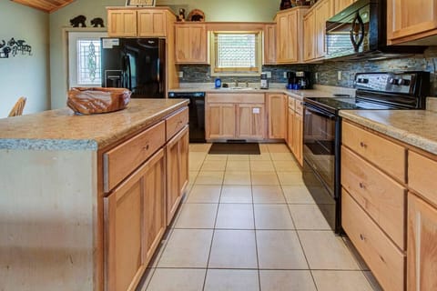 The kitchen is equipped with appliances, pots/pans, cookware, utensils, coffee maker, and more.