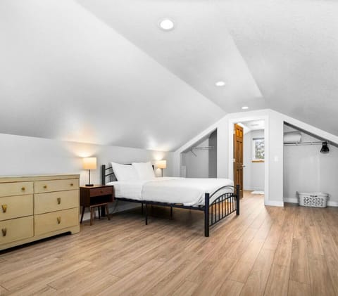 Bedroom with queen bed and dresser at Downtown Hideaway near East Bay in Traverse City.