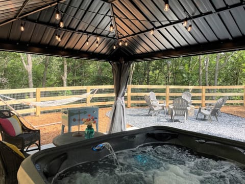 Covered hot tub with cafe lights for evenings