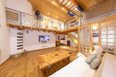 In the artistic and bright living space, there is a large, plush sofa - ideal for lounging