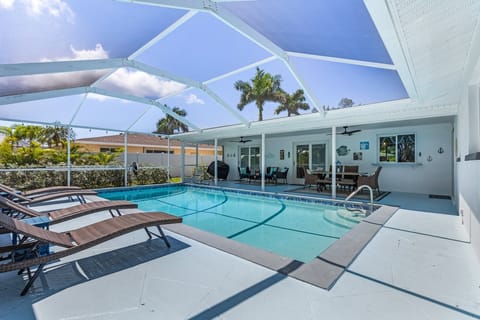 Outdoor caged pool area with solar heated pool.