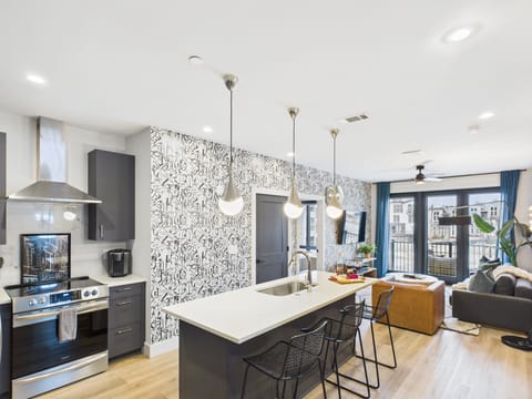 Fully equipped kitchen stocked with your basic cooking essentials. Includes stainless steel appliances, kitchen island, coffee machine, and toaster.