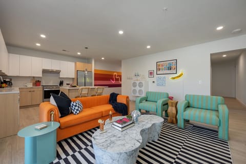 Spacious open floor plan with funky Andy Warhol inspired designer decor featuring multiple seating, smart TV, and access to private patio.