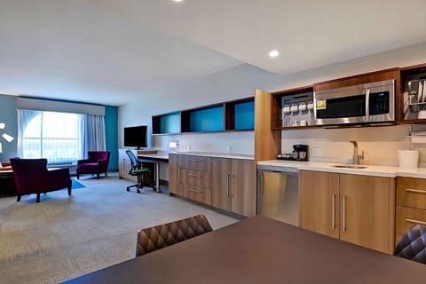 Cook and sip coffee easily in this open, modern kitchenette.