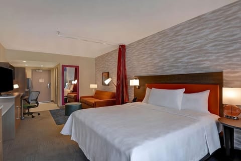 Relax in a spacious bedroom with plush pillows and warm lighting.
