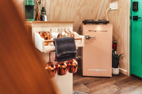 The A-frame comes with a Keurig machine, mini fridge, countertop burners, and the dining basics.