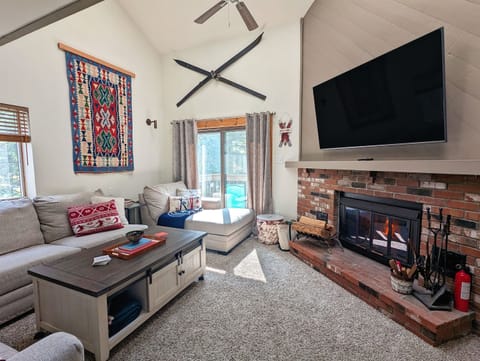 Our comfortable living room includes lots of natural light, a wood burning fire place, large television and seating for everyone.